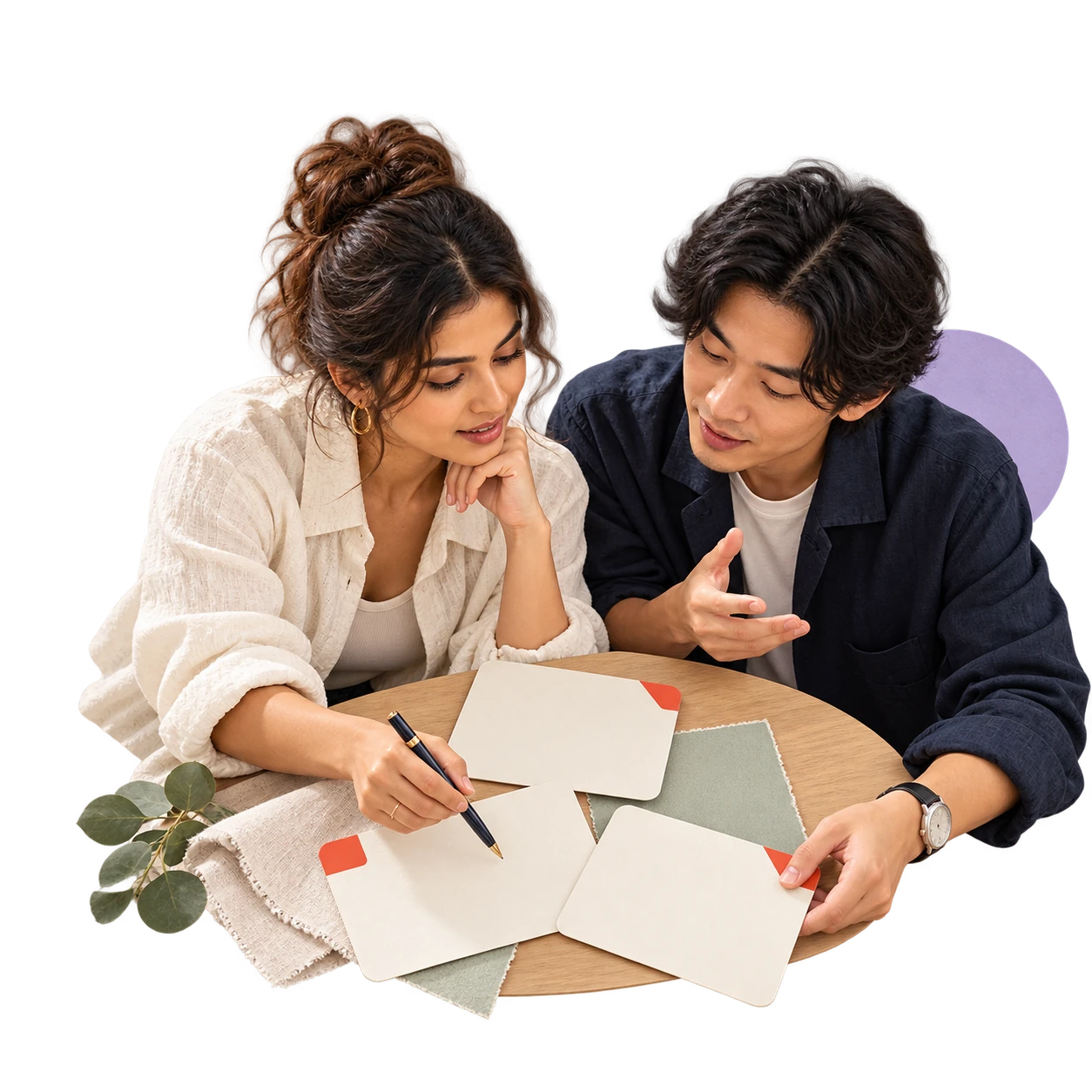 Creatives arranging campaign story cards and a navy pen on a light wood surface.